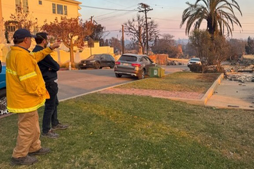 Senator Allen analyzes burned neighborhood with firefighter