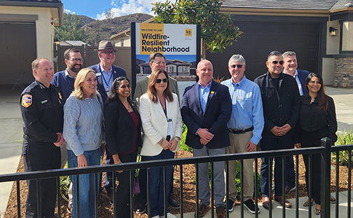 Senator Allen poses for group picture outside a home.