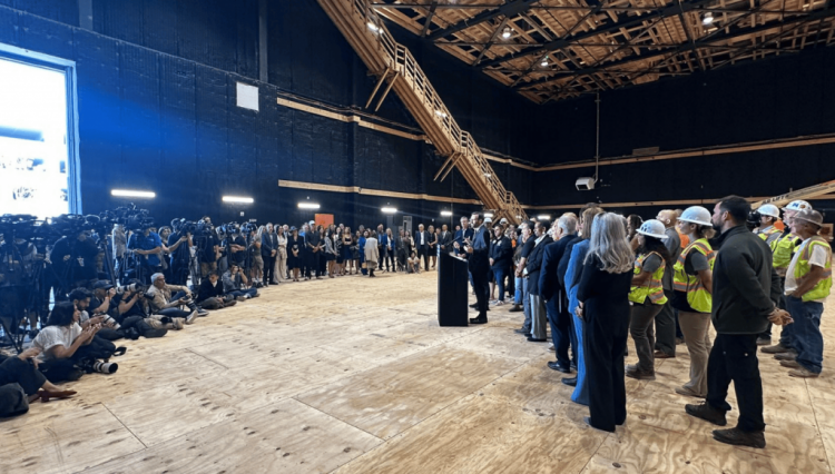 Senator Allen speaks to a crowd on a film set while celebrating the signing of AB 1138.