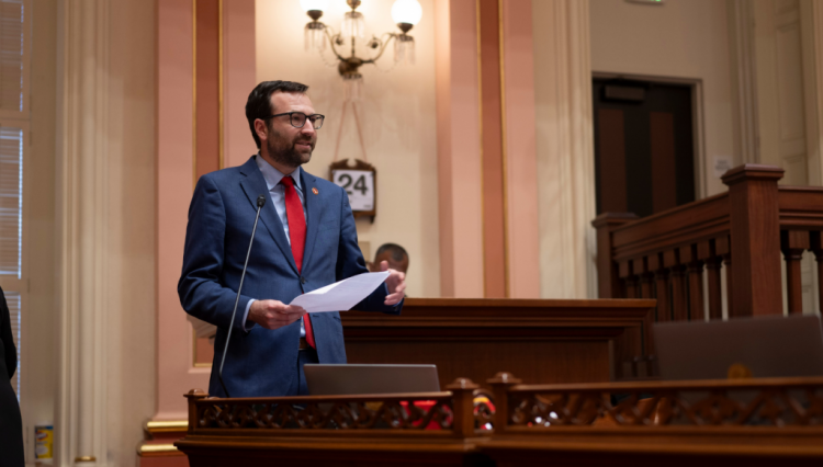 Senator Allen stands at his desk on the Senate Floor to present a bill.