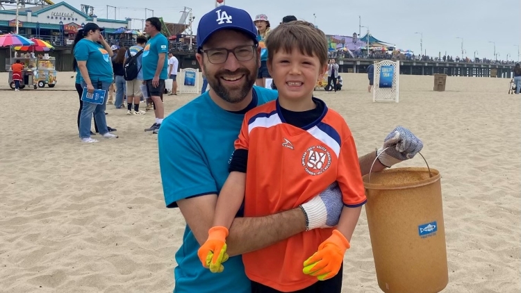 Senator Allen and son, Ezra, on beach for Coastal Cleanup Day