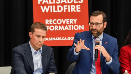 Senator Allen speaks into microphone during a fire recovery roundtable
